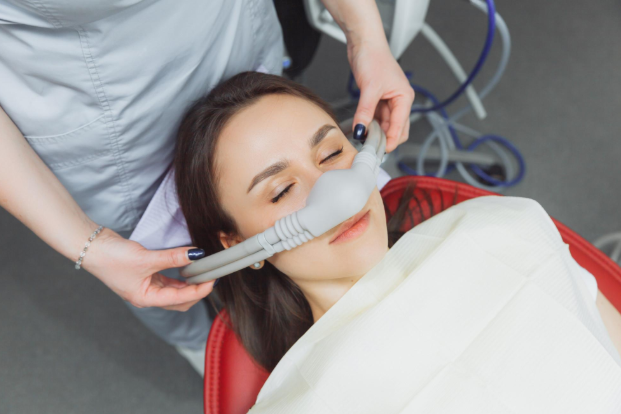 Patient wearing a nitrous oxide mask during dental treatment