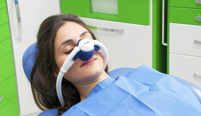 Child receiving nitrous oxide sedation during a dental appointment
