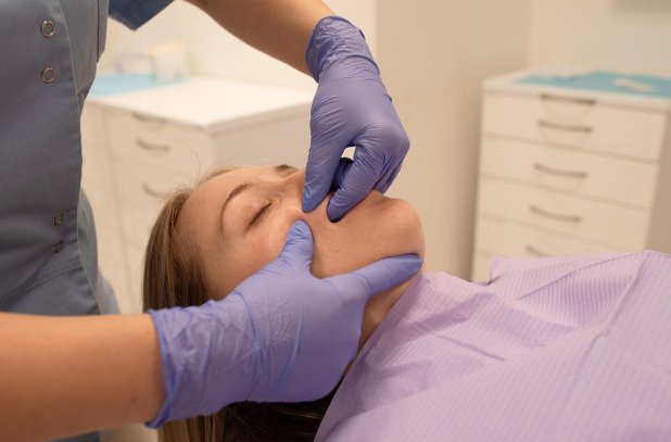 Dentist discussing TMJ treatment with a patient