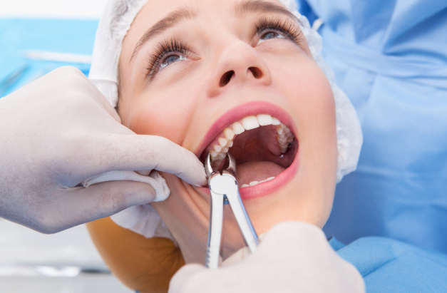 Dentist providing tooth extraction treatment