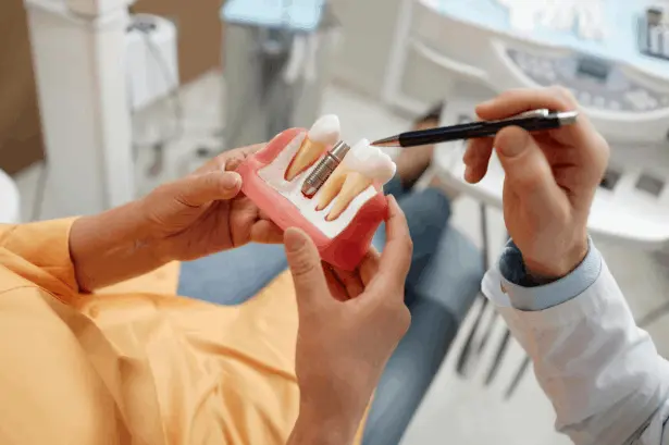 Dentist discussing dental implant treatment options with a patient